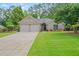 Beautiful single-story home featuring a two-car garage, brick facade, and a well-manicured lawn at 425 Greenmont Walk Ct, Alpharetta, GA 30009