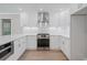 Modern kitchen with white cabinets, stainless steel appliances, and a functional layout at 425 Greenmont Walk Ct, Alpharetta, GA 30009