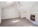 Living room with fireplace, hardwood floors, vaulted ceilings and a fan at 425 Greenmont Walk Ct, Alpharetta, GA 30009