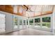 Light-filled sunroom with wood ceiling, views of backyard, and access to the outdoor patio at 425 Greenmont Walk Ct, Alpharetta, GA 30009