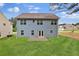 Expansive backyard view of a two-story home with blue siding, many windows, and a well-maintained lawn at 4401 Belcamp Rd, Union City, GA 30213
