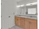 Bathroom featuring dual sinks, wood cabinets, and ample counter space at 4401 Belcamp Rd, Union City, GA 30213