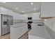 Well-lit kitchen boasts stainless steel appliances, an island, light countertops and stylish white cabinets at 4401 Belcamp Rd, Union City, GA 30213