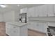 Bright kitchen features an island, modern appliances, and light countertops, and white cabinets at 4401 Belcamp Rd, Union City, GA 30213
