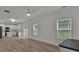 Bright, open-concept living room featuring hardwood floors, a ceiling fan, and modern kitchen in background at 4401 Belcamp Rd, Union City, GA 30213