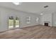 Expansive open-concept living room features hardwood floors, a fireplace, and doors to the backyard at 4401 Belcamp Rd, Union City, GA 30213