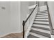 Elegant staircase with dark wood treads, white risers, and a classic banister at 4401 Belcamp Rd, Union City, GA 30213