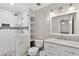 Modern bathroom features a glass shower, decorative tile accents, and updated vanity with marble countertops at 5037 Laurel Springs Se Way, Smyrna, GA 30082