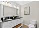 Elegant bathroom featuring double sinks, granite countertops and a large mirror at 5037 Laurel Springs Se Way, Smyrna, GA 30082