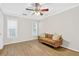 Neutral bedroom featuring a comfortable sofa, natural light from windows, and hardwood floors at 5037 Laurel Springs Se Way, Smyrna, GA 30082