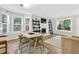 Inviting dining area with natural light, a fireplace, and hardwood floors, seamlessly connecting to the living space at 5037 Laurel Springs Se Way, Smyrna, GA 30082