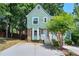Charming two-story home with green siding, brick accents, and a welcoming front porch staircase at 5037 Laurel Springs Se Way, Smyrna, GA 30082