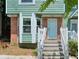 Charming home exterior with steps to the entrance featuring a light green facade and brick accents at 5037 Laurel Springs Se Way, Smyrna, GA 30082