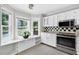 Bright kitchen featuring white cabinets, stainless steel appliances, and a bay window with a window seat at 5037 Laurel Springs Se Way, Smyrna, GA 30082