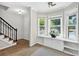 Bright living area featuring large windows, built-in storage, and a staircase with a black railing at 5037 Laurel Springs Se Way, Smyrna, GA 30082