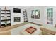 Bright living room with a white brick fireplace, modern decor and a large window at 5037 Laurel Springs Se Way, Smyrna, GA 30082