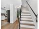 Interior view of a staircase with wood treads and a black railing, adjacent to the kitchen area at 5037 Laurel Springs Se Way, Smyrna, GA 30082