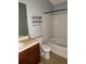 Bathroom with a standard shower-tub combination and vanity with dark cabinets at 6231 Redan Overlook, Lithonia, GA 30058