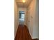 Hallway featuring wood look flooring with a view of a bedroom at the end of the hall at 6231 Redan Overlook, Lithonia, GA 30058