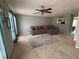 Spacious living room with comfortable seating and modern ceiling fan at 6231 Redan Overlook, Lithonia, GA 30058