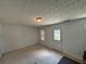 Living room showcasing neutral colored walls, a light fixture and a back door at 6231 Redan Overlook, Lithonia, GA 30058