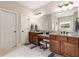 Elegant bathroom with dual sinks, granite countertops, and vanity seating, offering a luxurious experience at 5830 Caveat Ct, Suwanee, GA 30024