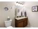 Bathroom featuring granite countertop and vanity, decorative mirror, and artwork at 5830 Caveat Ct, Suwanee, GA 30024