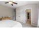 Bedroom with ensuite access and featuring neutral paint, carpet, and double closets at 5830 Caveat Ct, Suwanee, GA 30024