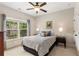 Bedroom boasts natural light, neutral colors, and an expansive backyard view at 5830 Caveat Ct, Suwanee, GA 30024