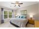 Bright bedroom featuring a queen bed, large window, and tasteful decorative artwork at 5830 Caveat Ct, Suwanee, GA 30024