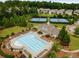 Aerial view of a community pool, tennis courts, clubhouse surrounded by green landscaping at 5830 Caveat Ct, Suwanee, GA 30024