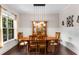 The dining room showcases a hardwood table with seating for six and modern lighting at 5830 Caveat Ct, Suwanee, GA 30024
