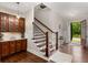 Inviting entryway with staircase, hardwood floors, and built-in cabinets, perfect for welcoming guests at 5830 Caveat Ct, Suwanee, GA 30024