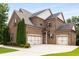 Spacious home with three-car garage and extra wide drive for additional parking at 5830 Caveat Ct, Suwanee, GA 30024
