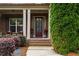 Inviting front porch with brick columns, charming chairs, and a well-maintained lawn at 5830 Caveat Ct, Suwanee, GA 30024