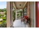 Inviting front porch with charming chairs and view of a beautifully landscaped lawn at 5830 Caveat Ct, Suwanee, GA 30024