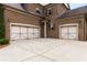 Spacious two-car garage with carriage-style doors and a concrete driveway at 5830 Caveat Ct, Suwanee, GA 30024