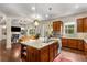 Bright kitchen with stainless appliances and a center island overlooking the living area at 5830 Caveat Ct, Suwanee, GA 30024