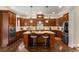 Spacious kitchen with stainless steel appliances, wooden cabinetry, and a center island with seating at 5830 Caveat Ct, Suwanee, GA 30024