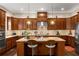 Spacious kitchen with stainless steel appliances, wooden cabinetry, and a center island with seating at 5830 Caveat Ct, Suwanee, GA 30024