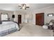Large bedroom featuring neutral carpet, a treadmill, and access to closet space for added convenience at 5830 Caveat Ct, Suwanee, GA 30024