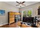 Office space with hardwood flooring features a large window and built in cabinet space with fish tank at 5830 Caveat Ct, Suwanee, GA 30024