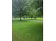 Lush green park with mature trees, walking path, and open space at 5830 Caveat Ct, Suwanee, GA 30024