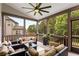 The screened in patio shows outdoor seating, a ceiling fan and views of the backyard at 5830 Caveat Ct, Suwanee, GA 30024