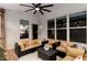 Comfortable covered patio featuring a ceiling fan and cozy seating area for outdoor relaxation at 5830 Caveat Ct, Suwanee, GA 30024