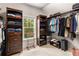 Organized walk-in closet featuring shelves, hanging racks, and ample storage space for clothing and accessories at 5830 Caveat Ct, Suwanee, GA 30024