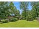 Spacious backyard with lush green grass and mature trees offering shade and privacy at 4653 Ridgewood Dr, Forest Park, GA 30297