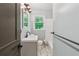 Modern bathroom featuring tile flooring, updated fixtures, and a window providing natural light at 4653 Ridgewood Dr, Forest Park, GA 30297