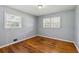 Bedroom featuring hardwood floors, neutral paint, and large windows offering plenty of natural light at 4653 Ridgewood Dr, Forest Park, GA 30297