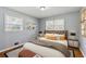 Well-decorated bedroom with a comfortable bed, stylish decor, and large windows for a bright and inviting space at 4653 Ridgewood Dr, Forest Park, GA 30297